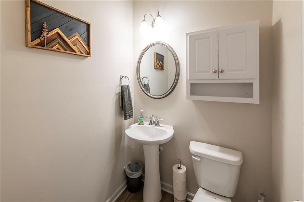 1182 Westhampton Way Villa Rica, GA 30180 - Photo 11 of 26 a bathroom with a toilet sink and mirror