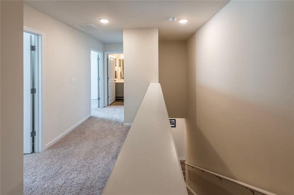 1182 Westhampton Way Villa Rica, GA 30180 - Photo 13 of 26 en view of hallway with stairs