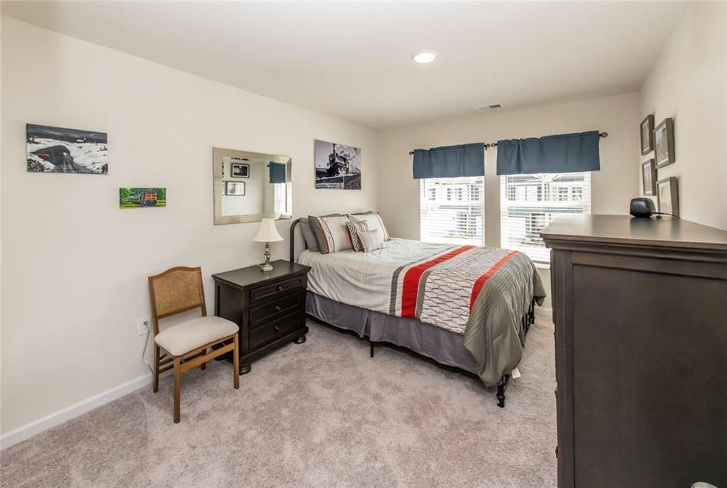 1182 Westhampton Way Villa Rica, GA 30180 - Photo 14 of 26 a bedroom with a bed and a chair