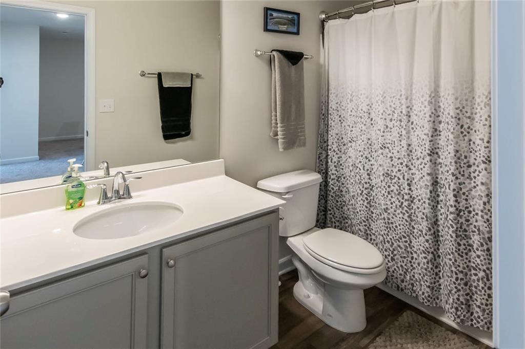 1182 Westhampton Way Villa Rica, GA 30180 - Photo 16 of 26 a bathroom with a sink toilet and shower
