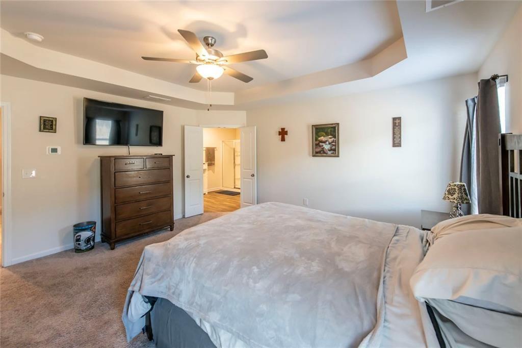 1182 Westhampton Way Villa Rica, GA 30180 - Photo 19 of 26 a bedroom with a bed and a chandelier