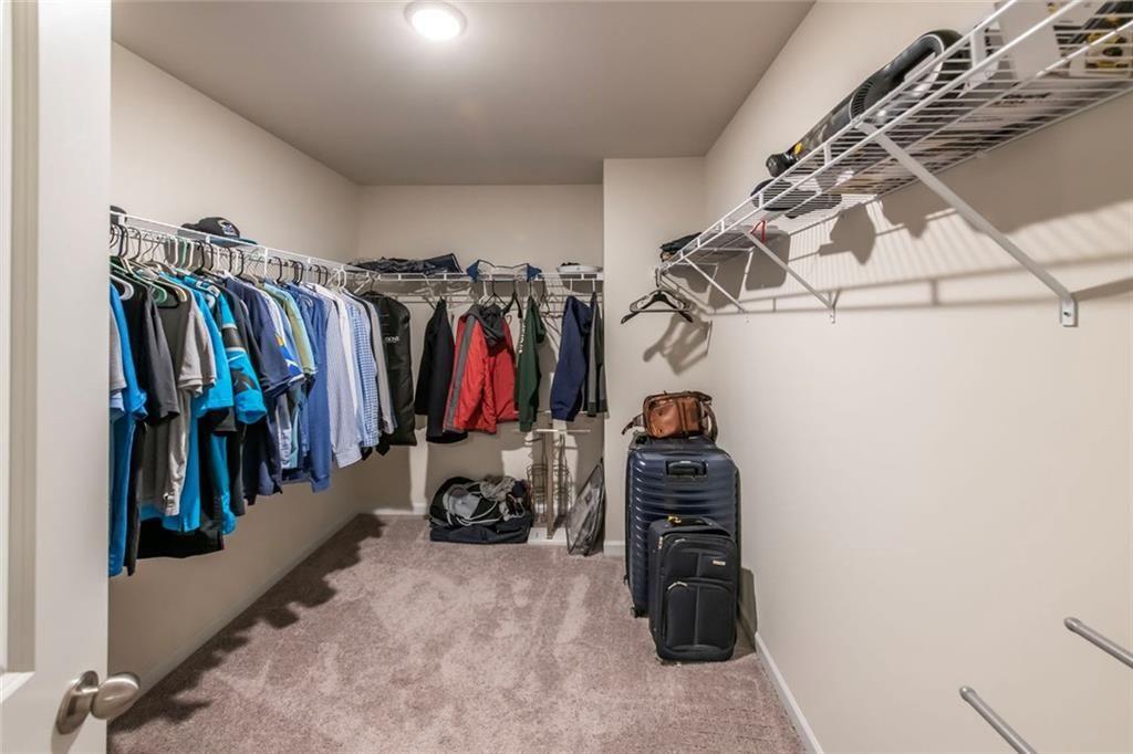 1182 Westhampton Way Villa Rica, GA 30180 - Photo 22 of 26 a view of walk in closet with clothes and shoes