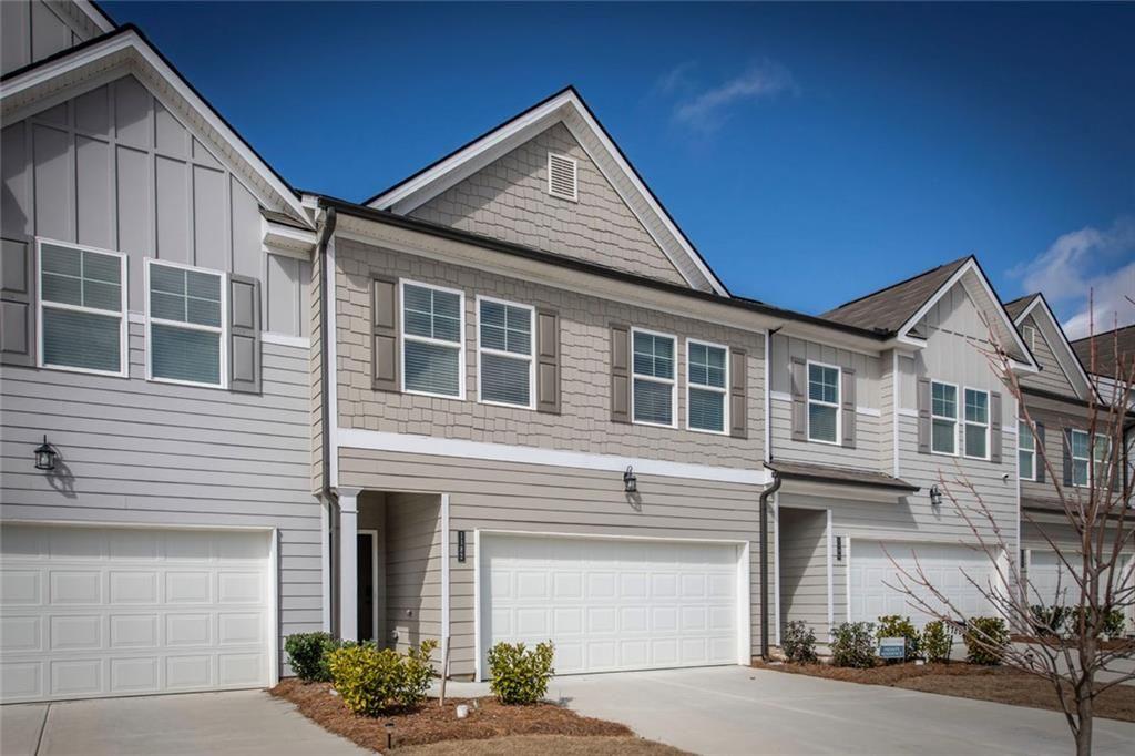 1182 Westhampton Way Villa Rica, GA 30180 - Photo 25 of 26 a front view of a house with a yard and garage