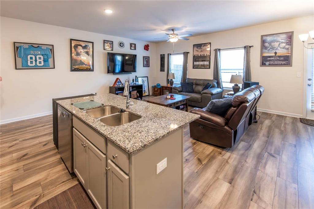 1182 Westhampton Way Villa Rica, GA 30180 - Photo 7 of 26 a living room with furniture and a wooden floor