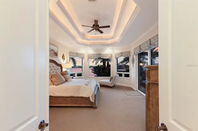 a view of a dining room and livingroom with furniture wooden floor a chandelier