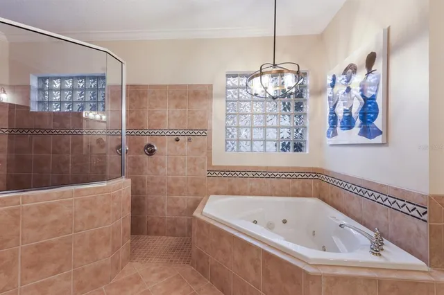 a spacious bedroom with a bed and ceiling fan