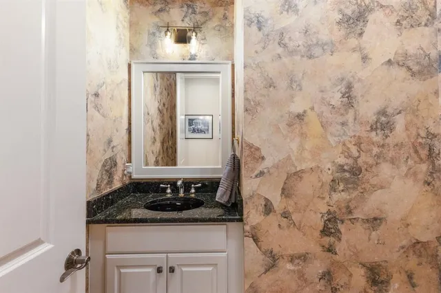 a kitchen with a stove and a clock on wall