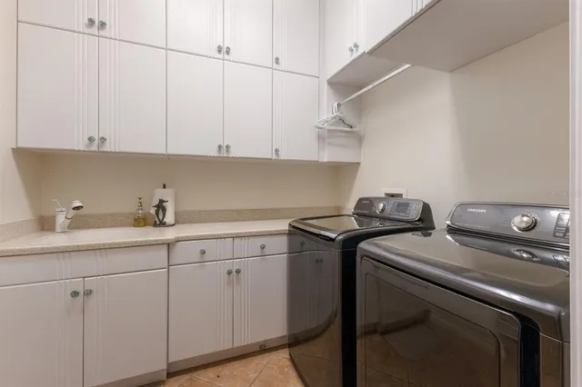 a front view of a house with yard and lake view