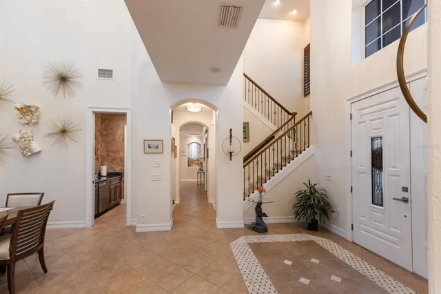 a kitchen with a stove a refrigerator and a dining table with wooden floor