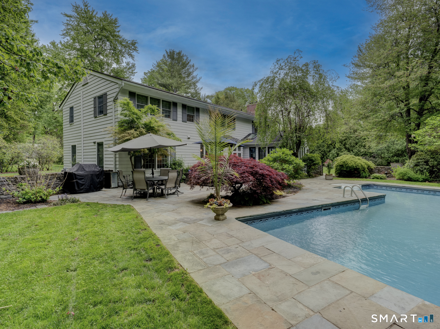 78 Windtree Street Torrington, CT 06790 - Photo 10 of 40 a view of a patio with table and chairs under an umbrella