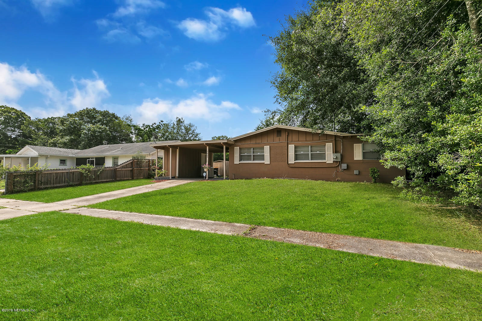 7464 Centauri Road Jacksonville, FL 32210 - Photo 1 of 15 a front view of a house with a garden