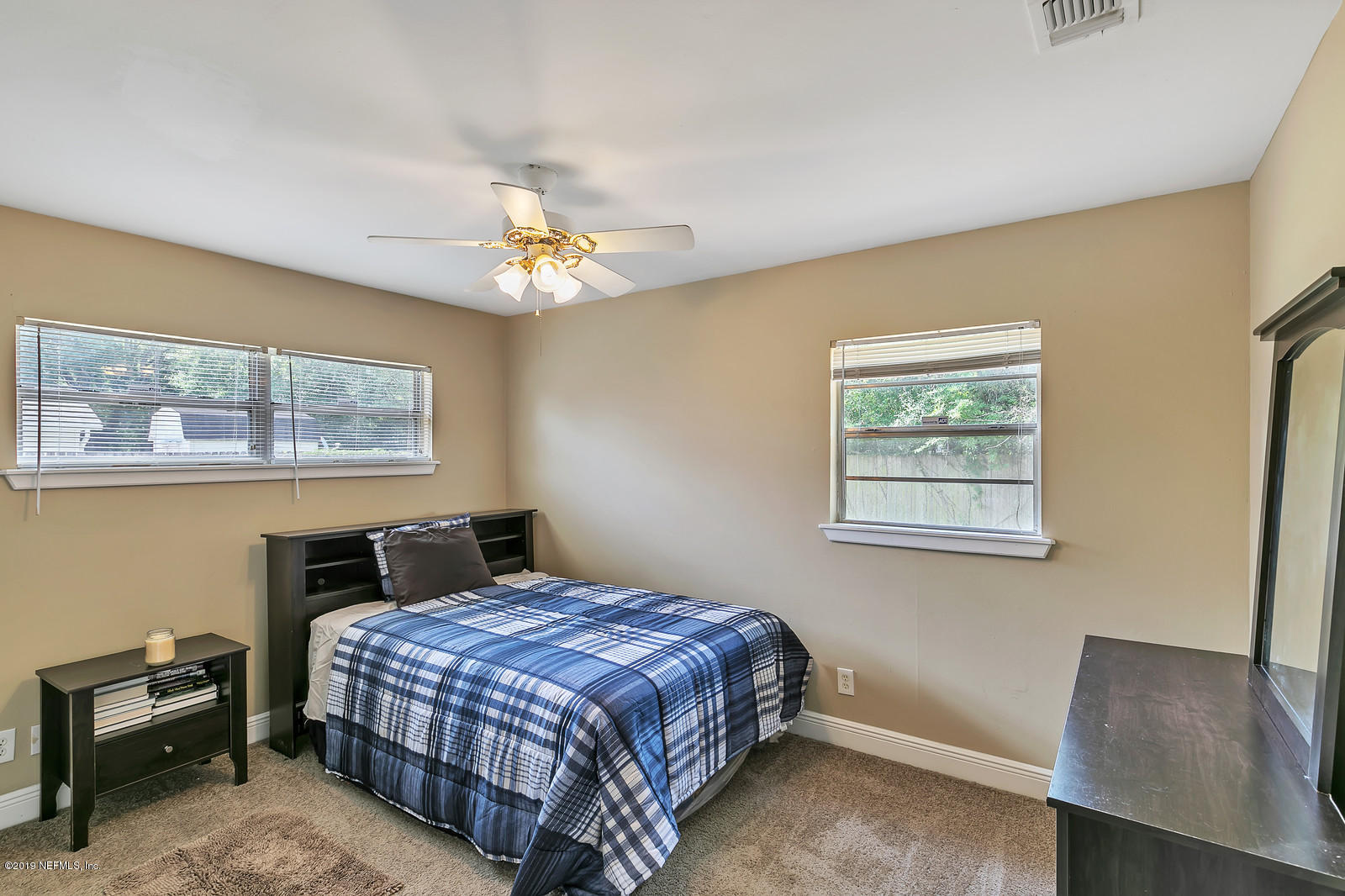 7464 Centauri Road Jacksonville, FL 32210 - Photo 11 of 15 a bedroom with a bed and a chair