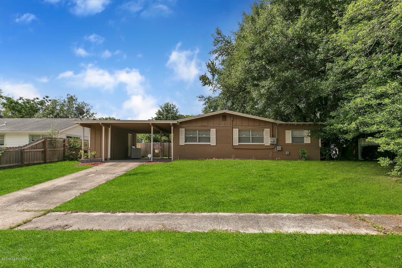 7464 Centauri Road Jacksonville, FL 32210 - Photo 2 of 15 a front view of a house with a yard