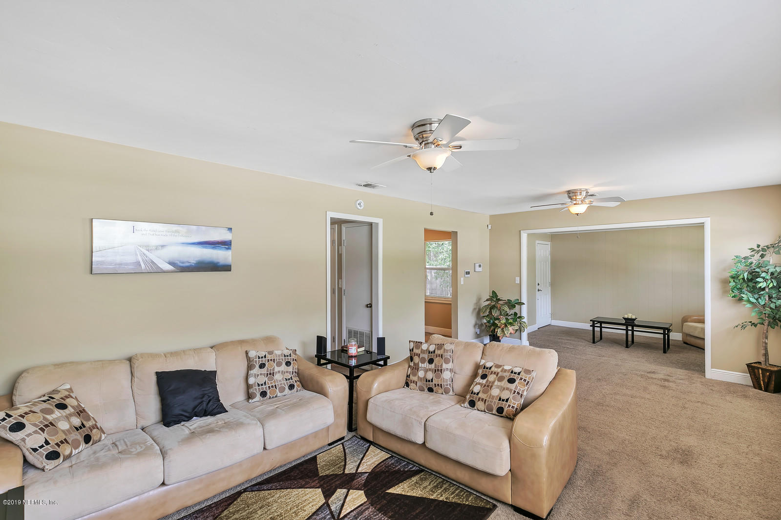 7464 Centauri Road Jacksonville, FL 32210 - Photo 5 of 15 a living room with furniture and a large window