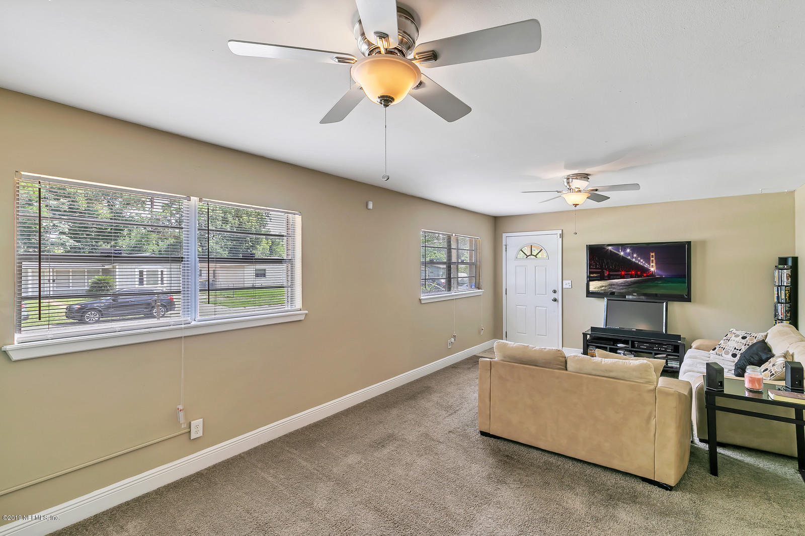 7464 Centauri Road Jacksonville, FL 32210 - Photo 6 of 15 a living room with furniture and a flat screen tv