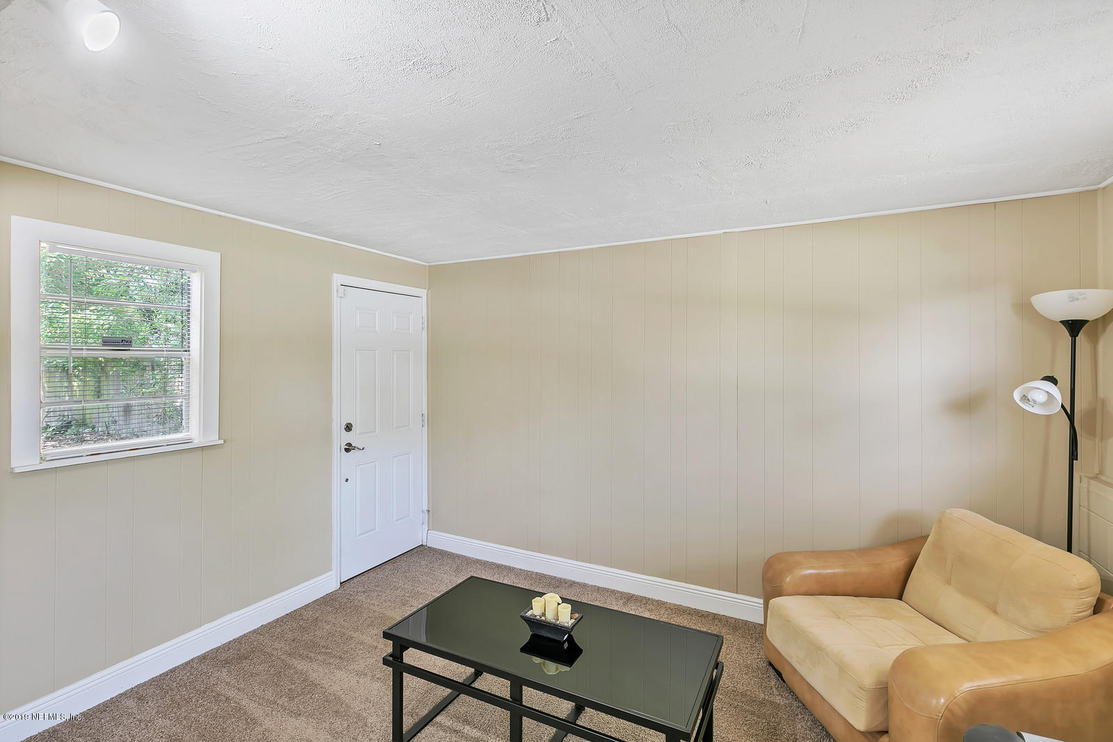 7464 Centauri Road Jacksonville, FL 32210 - Photo 10 of 15 a living room with a couch and a window