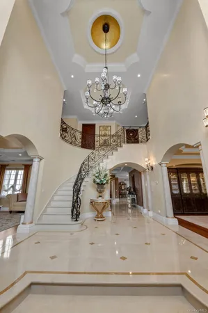 a view of a dining room with furniture a chandelier and wooden floor