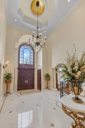 a dining room with furniture a chandelier and wooden floor