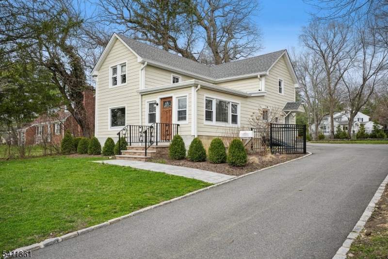 a front view of a house with a garden and plants