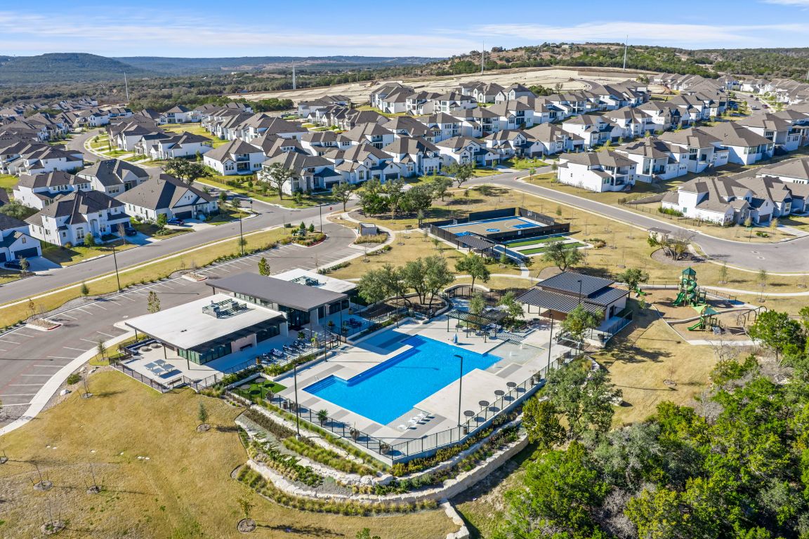 2660 Novara Trail Leander, TX 78641 - Photo 19 of 22 Aerial view of property's location with a pool area and rolling hills