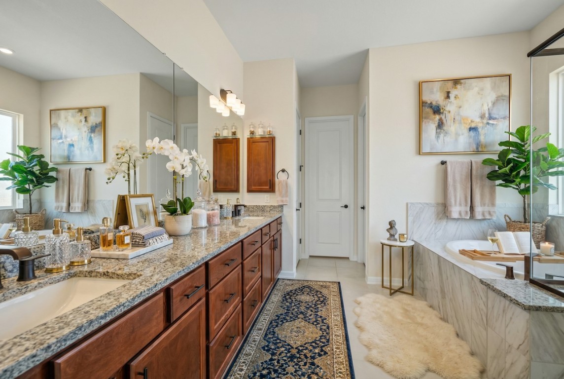 2660 Novara Trail Leander, TX 78641 - Photo 9 of 22 Full bathroom featuring double vanity, a bath, and light tile patterned floors