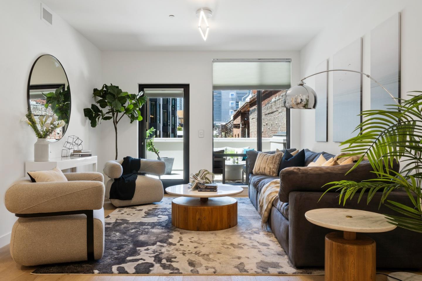 a living room with furniture a potted plant and a fireplace