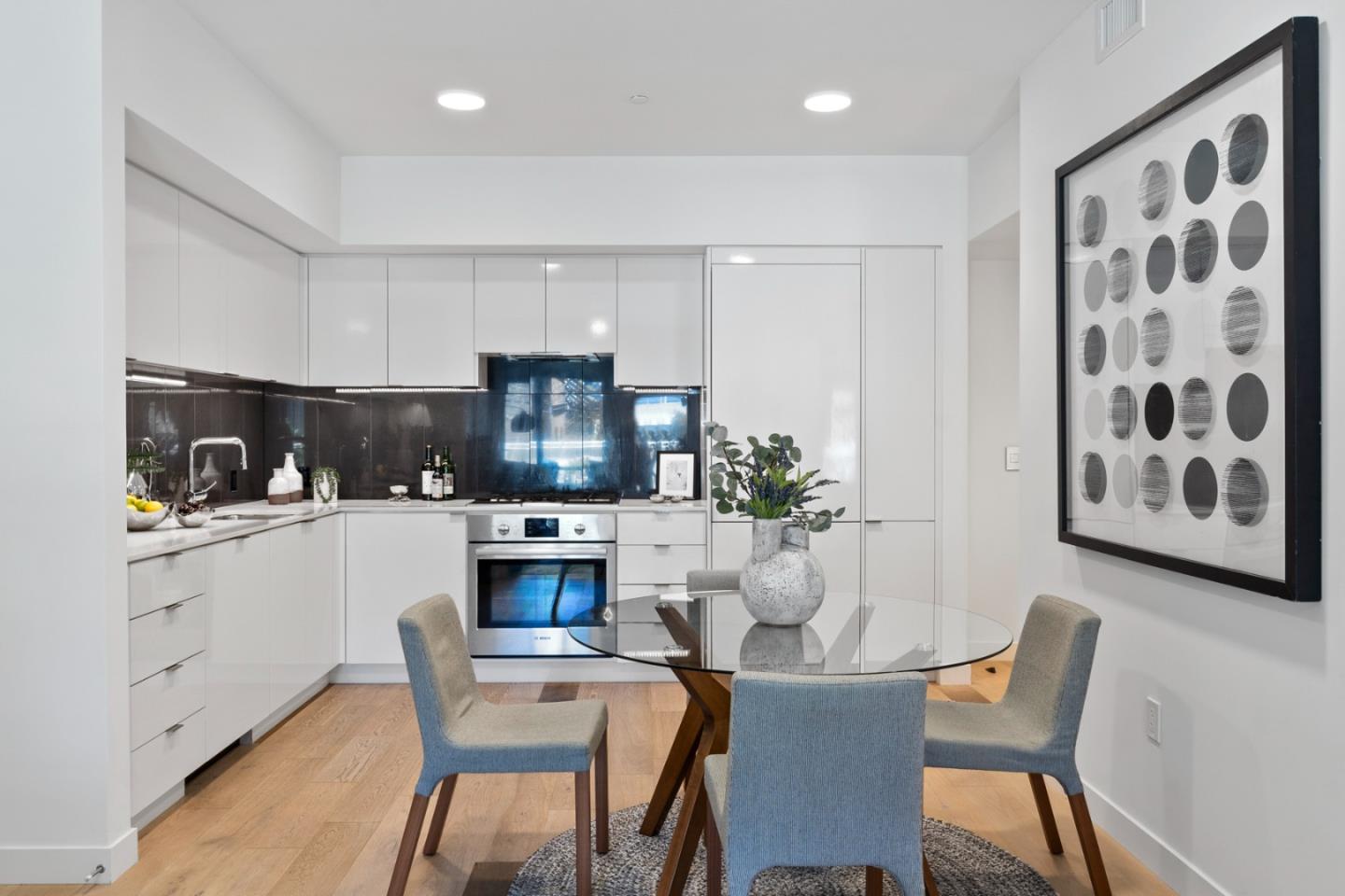 99 Rausch Street, Unit 219 San Francisco, CA 94103 - Photo 11 of 57 a kitchen with a table chairs refrigerator and microwave