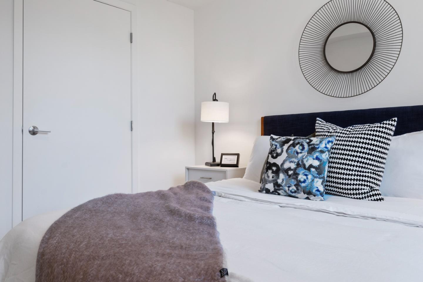 99 Rausch Street, Unit 219 San Francisco, CA 94103 - Photo 18 of 57 a bedroom with a bed and a chandelier