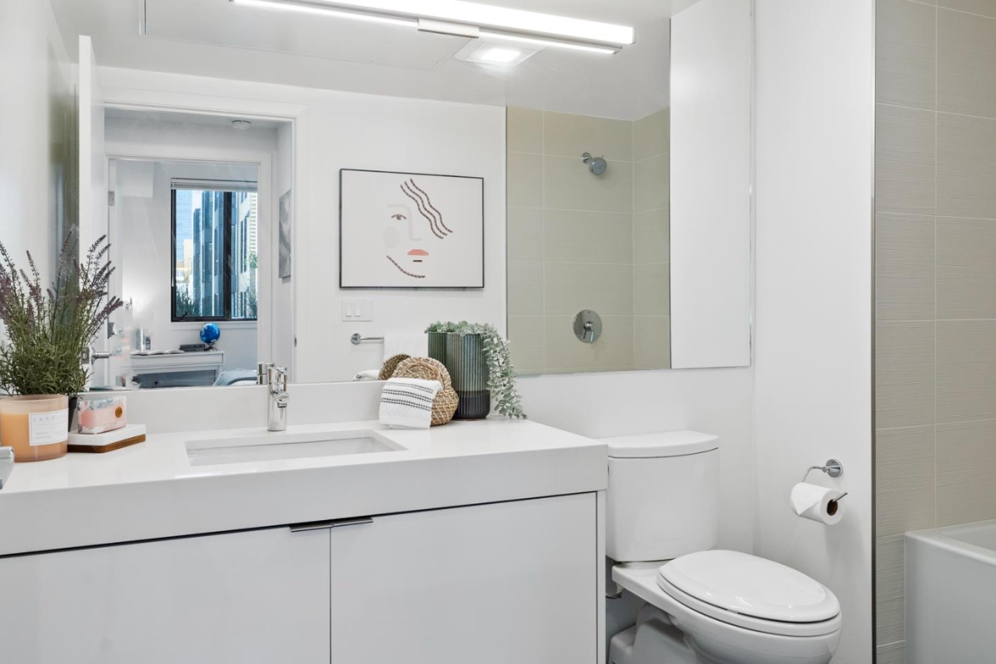 99 Rausch Street, Unit 219 San Francisco, CA 94103 - Photo 19 of 57 a bathroom with a sink a toilet and mirror