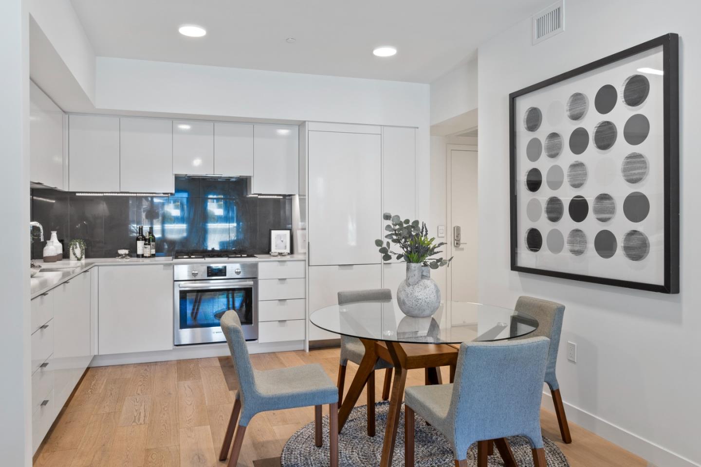 99 Rausch Street, Unit 219 San Francisco, CA 94103 - Photo 3 of 57 a kitchen with stainless steel appliances granite countertop a dining table chairs and a refrigerator