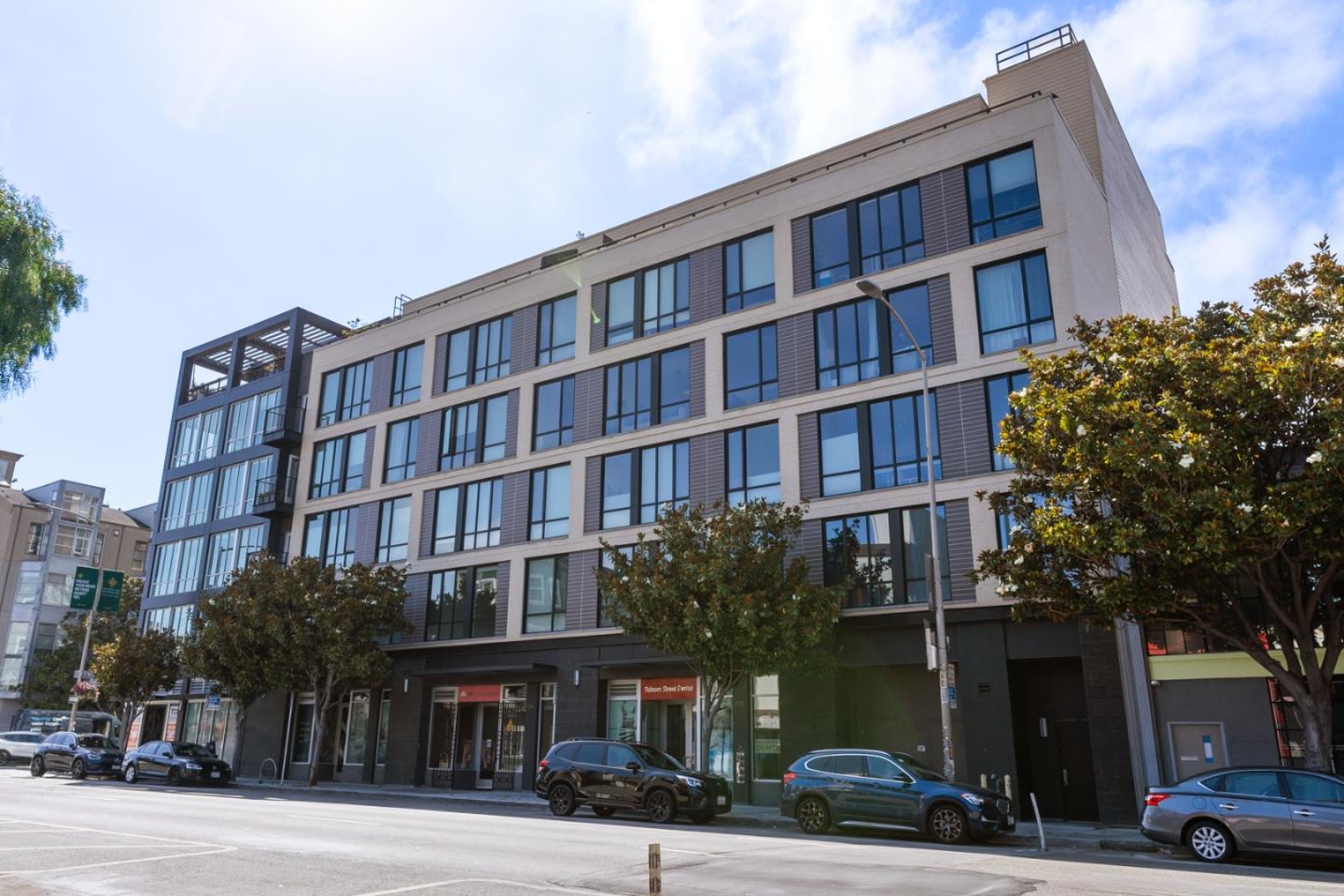 99 Rausch Street, Unit 219 San Francisco, CA 94103 - Photo 52 of 57 a front view of a building with lot of cars and trees