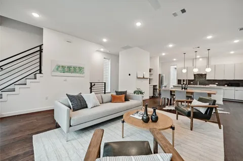 a living room with furniture and kitchen view