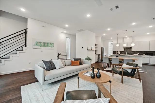 a living room with furniture and kitchen view