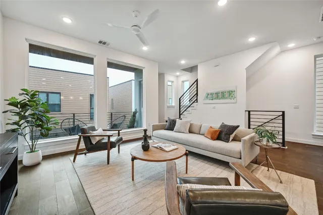 a living room with furniture and a potted plant