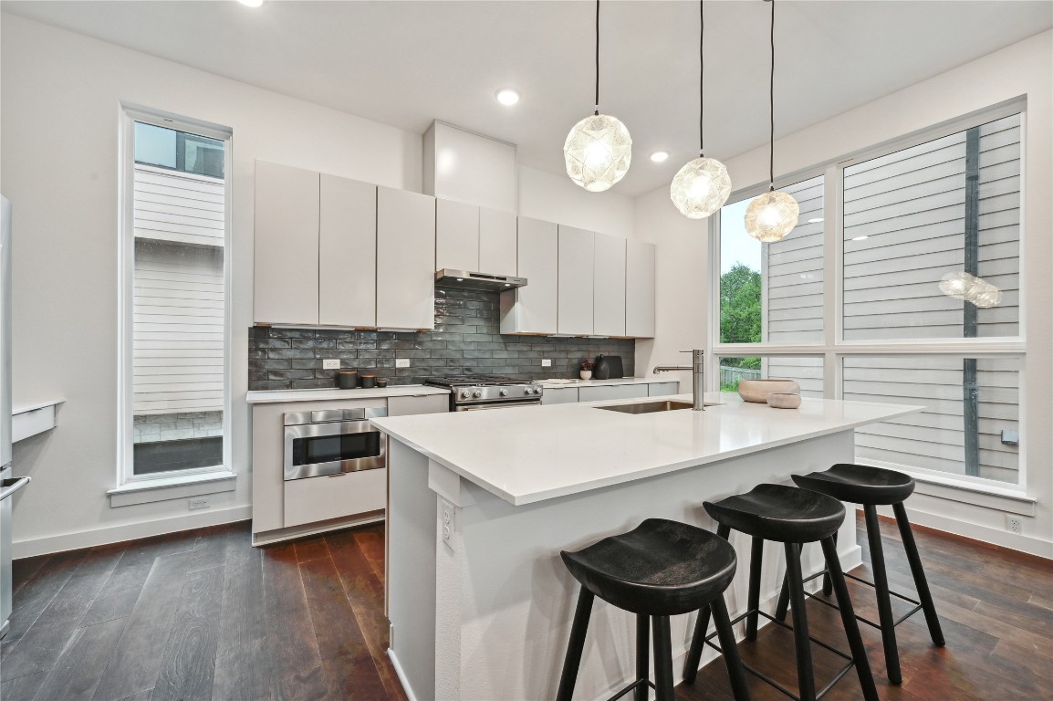 6821 Wolfcreek Pass, Unit 12 Austin, TX 78749 - Photo 15 of 32 a kitchen with a sink cabinets and wooden floor