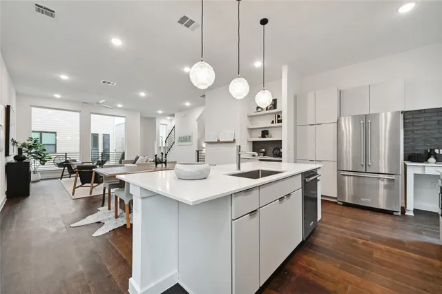 a kitchen with stainless steel appliances a stove center island refrigerator and cabinets