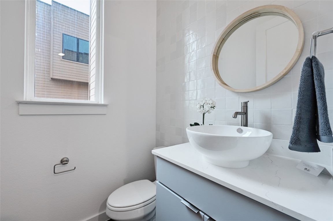 6821 Wolfcreek Pass, Unit 12 Austin, TX 78749 - Photo 18 of 32 a bathroom with a sink mirror and toilet