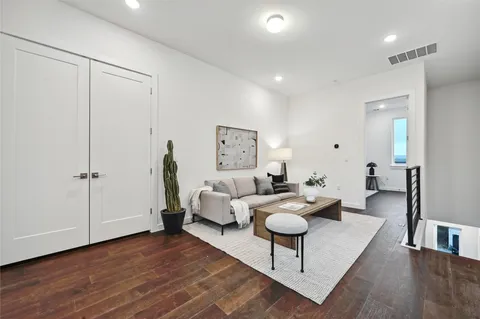 a living room with furniture and wooden floor