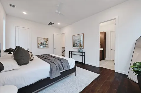 a bedroom with a bed and a potted plant