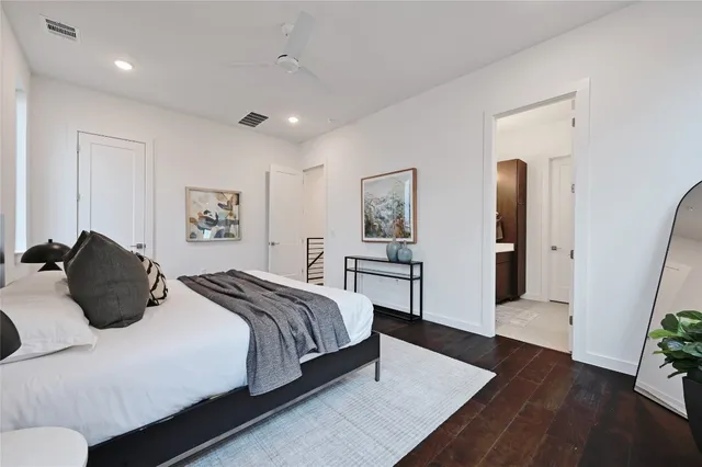 a bedroom with a bed and a potted plant