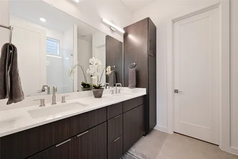 a bathroom with a double vanity sink and a mirror