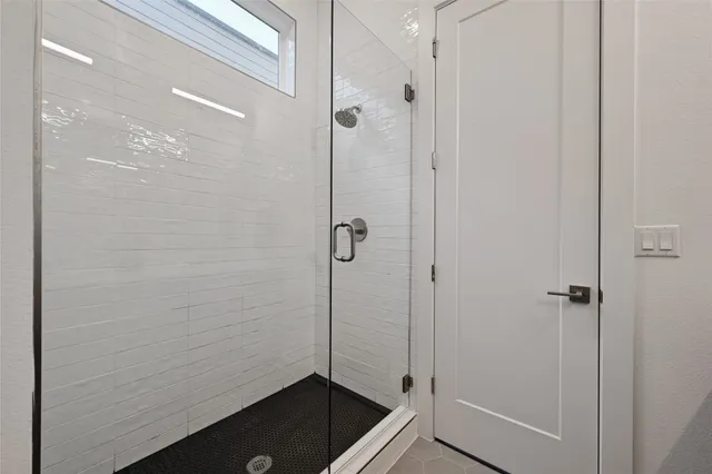 a bathroom with a granite countertop shower