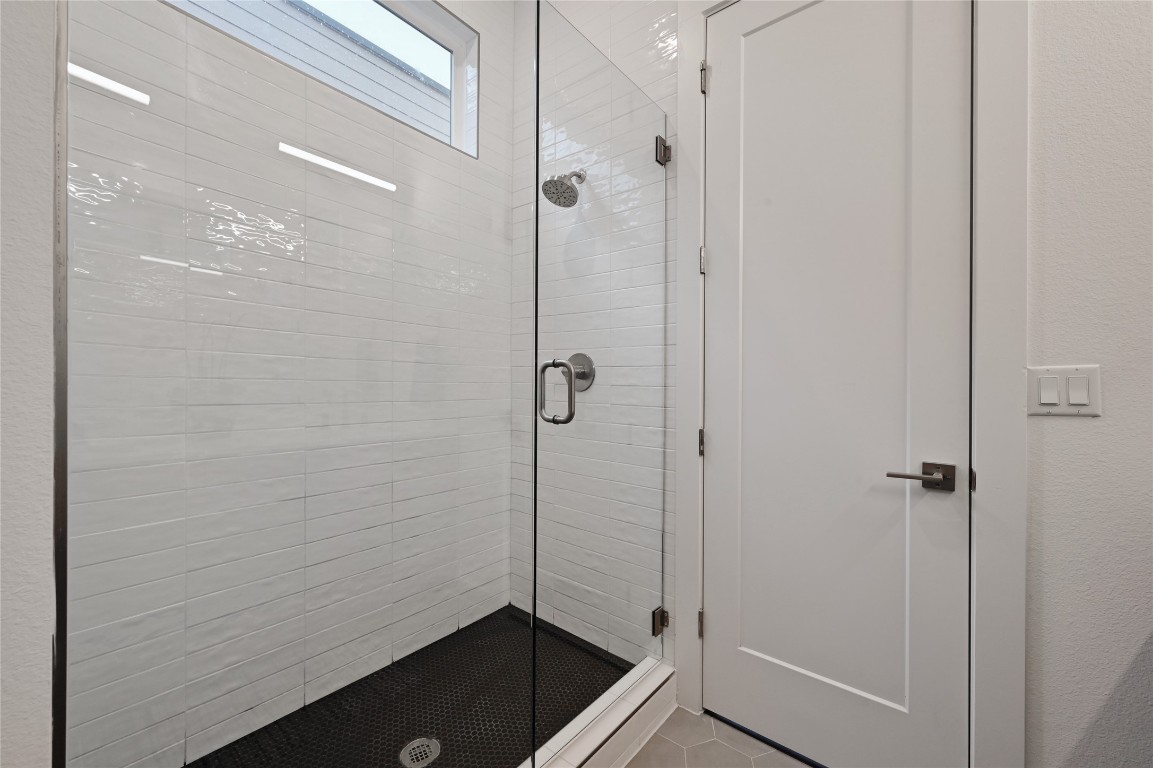 6821 Wolfcreek Pass, Unit 12 Austin, TX 78749 - Photo 25 of 32 a bathroom with a granite countertop shower