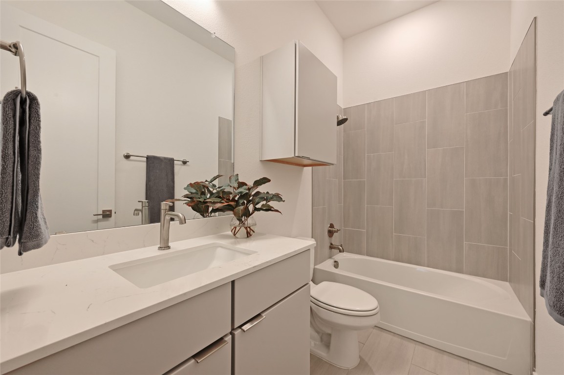 6821 Wolfcreek Pass, Unit 12 Austin, TX 78749 - Photo 27 of 32 a bathroom with a sink a toilet and shower