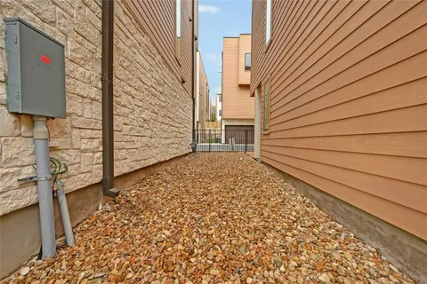a backyard of a house with table and chairs