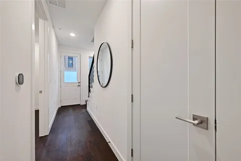 a view of a room with wooden floor and entryway