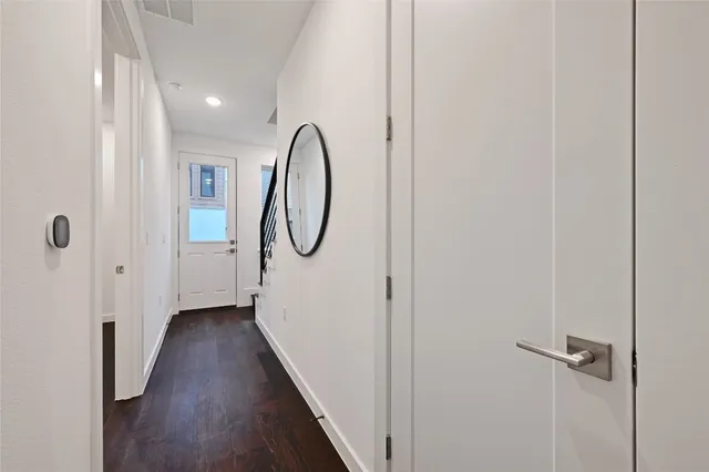 a view of a room with wooden floor and entryway