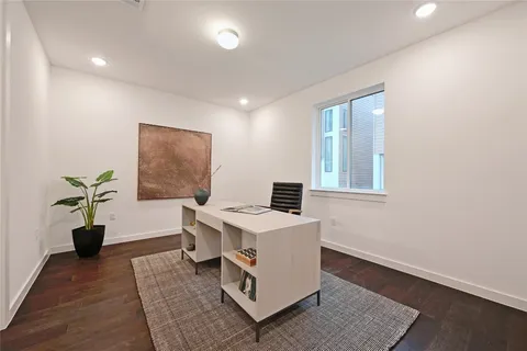 a living room with a couch and a potted plant