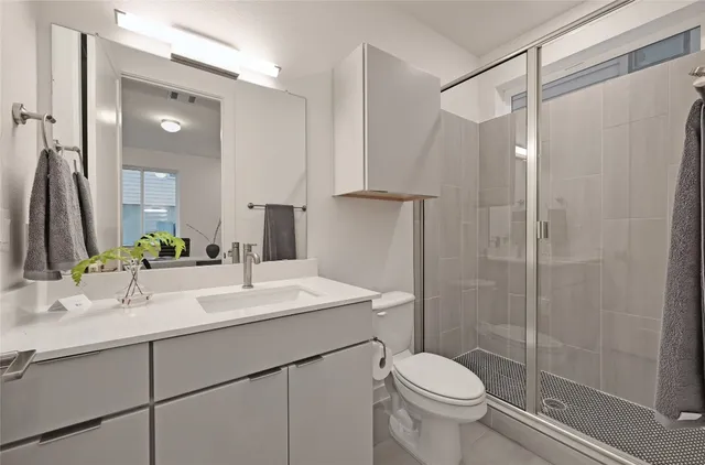 a bathroom with a sink toilet and shower