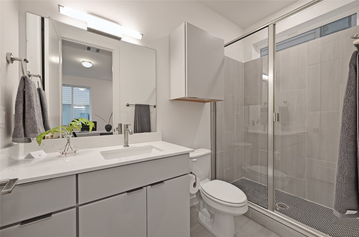 6821 Wolfcreek Pass, Unit 12 Austin, TX 78749 - Photo 10 of 32 a bathroom with a sink toilet and shower